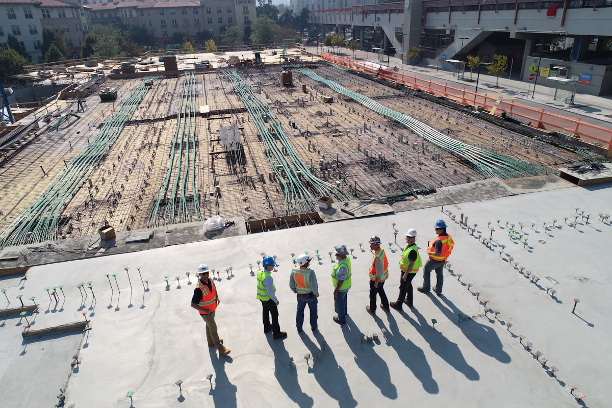 Equipa de trabalhadores de construção civil com capacetes numa obra